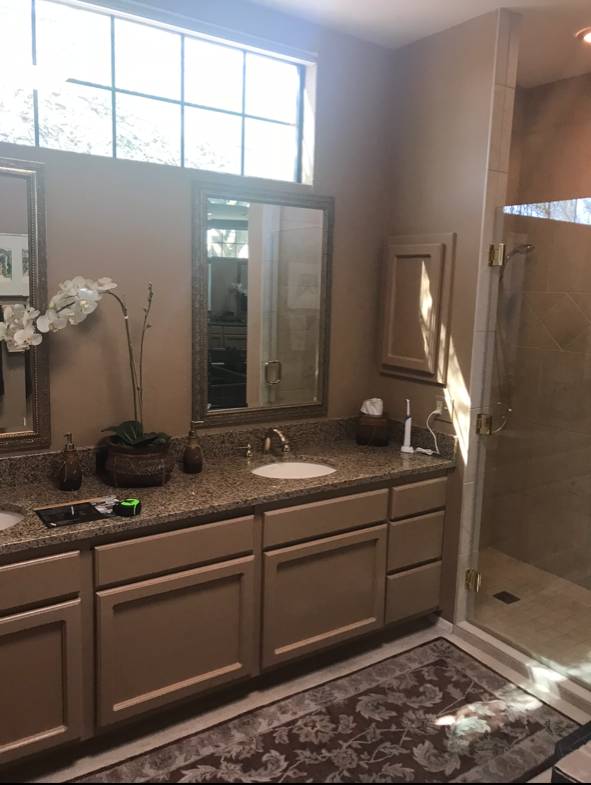 Schneider primary bathroom before remodel — Tucson, beige vanity with granite top and framed mirrors before the update