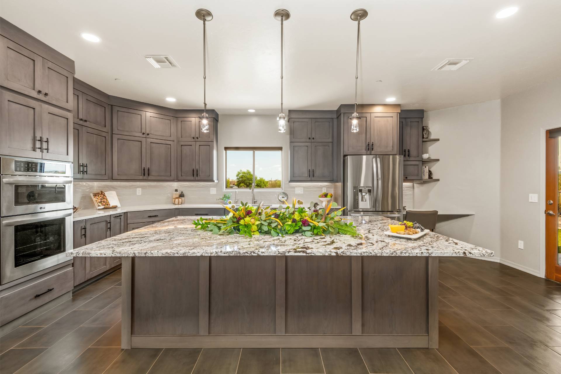 tobey-kitchen-island-01 Tobey kitchen anchored by a broad granite island in warm gray-stained cabinetry